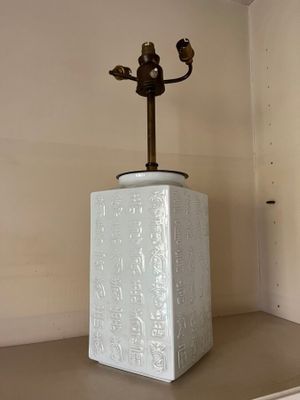 a lamp that is sitting on a shelf in a room