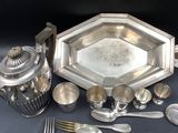 a silver plate and silverware on a table