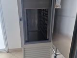 an image of a refrigerator in a room with tile flooring