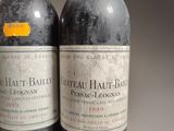 two bottles of red wine sitting next to each other on a table