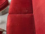 two red chairs and a table in a living room