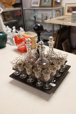 bottles and glasses on a tray on a table in a room
