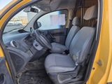 a yellow truck with a black seat in the back