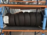 a stack of tires sitting on a shelf in a warehouse