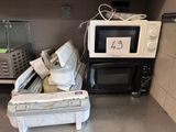 a microwave sitting on top of a stack of appliances