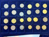 a box of gold coins sitting on top of a table