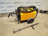 an image of a machine with a hose and a wren on the ground