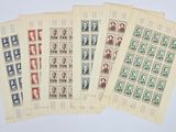 four different stamps of different colors and sizes on a white surface