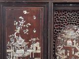 a cabinet that has a lot of asian designs on it