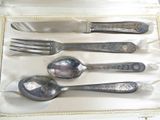 silverware in a white box on a table with a white table cloth