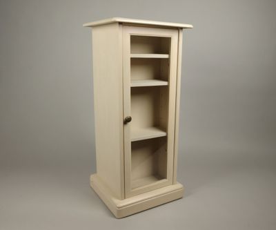 une petite armoire avec des étagères, sur fond gris