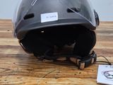 a helmet sitting on a wooden table with a tag attached to it