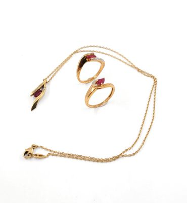 a close up of a gold necklace and a pair of rings on a chain