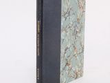 the book is sitting on a white surface with a blue cover