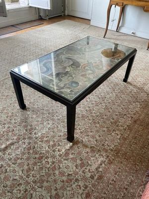 une table basse avec un plateau en verre dans un salon