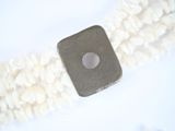 a piece of metal and rice on a white surface