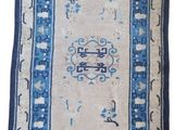 a blue and white rug with an oriental design on it
