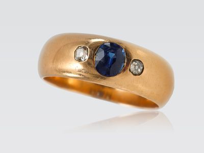 Bague jonc en or sertie d'un saphir de taille ovale épaulé d…