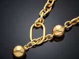 a close up of a gold chain with a ball on it