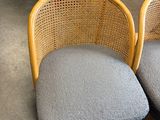 three wicker chairs with blue cushions in a store with other items