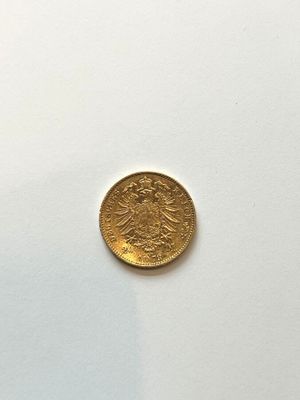 an image of a gold coin on a white surface