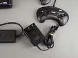 a game controller, a charger, and a charger on a table