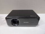 an image of a small projector sitting on top of a white table
