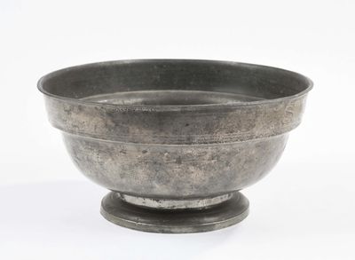 a metal bowl that is sitting on top of a table