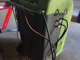 a green machine that is sitting in a garage