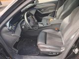 the interior of a car with the door open and the driver seat down