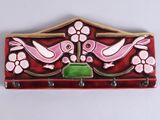 a picture of a red and pink coat rack with two birds on it
