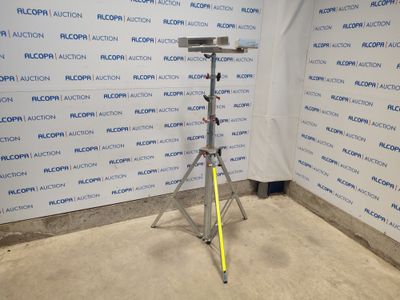 a camera on a tripod in front of a wall