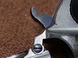 a close up of a gun on a brown surface