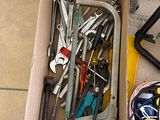 a box full of tools sitting on the floor next to a window