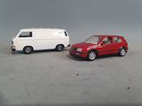 two toy cars sitting next to each other on a table