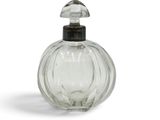 a clear glass bottle with a black top on a white surface