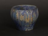 a blue and yellow bowl sitting on a black surface