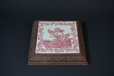 an old wooden box with a pink and white design on it