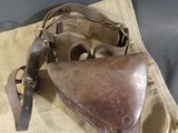 a brown leather bag with a brown leather holster on it