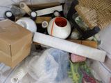 a box full of assorted items sitting on a bed