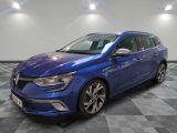 a blue car parked on a checkered floor in a garage