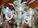 a glass chandelier hanging from a ceiling in a room