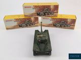 three boxed boxes of dinky military vehicles on a white surface