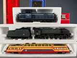 two trains that are sitting on a shelf next to each other