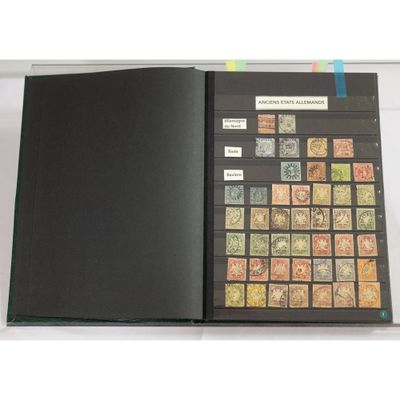 an open book with stamps on it sitting on top of a table