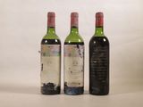 trois bouteilles de vin posées l'une à côté de l'autre sur une table