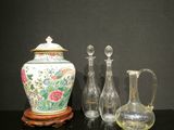 three vases and a pitcher sitting on a table