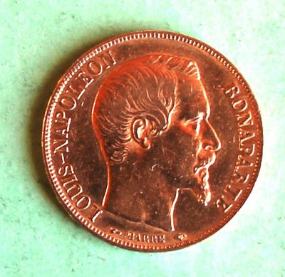 a close up of a penny on a green surface