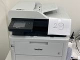 the printer is sitting on top of the desk next to the computer