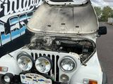 a white jeep that is parked in front of a building